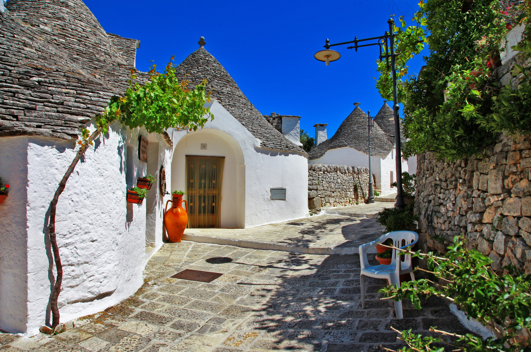 Unique Trulli houses with conical roofs in Alberobello, Italy, P